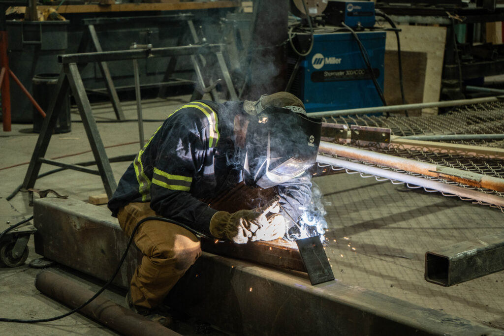 person sitting and doing welding work