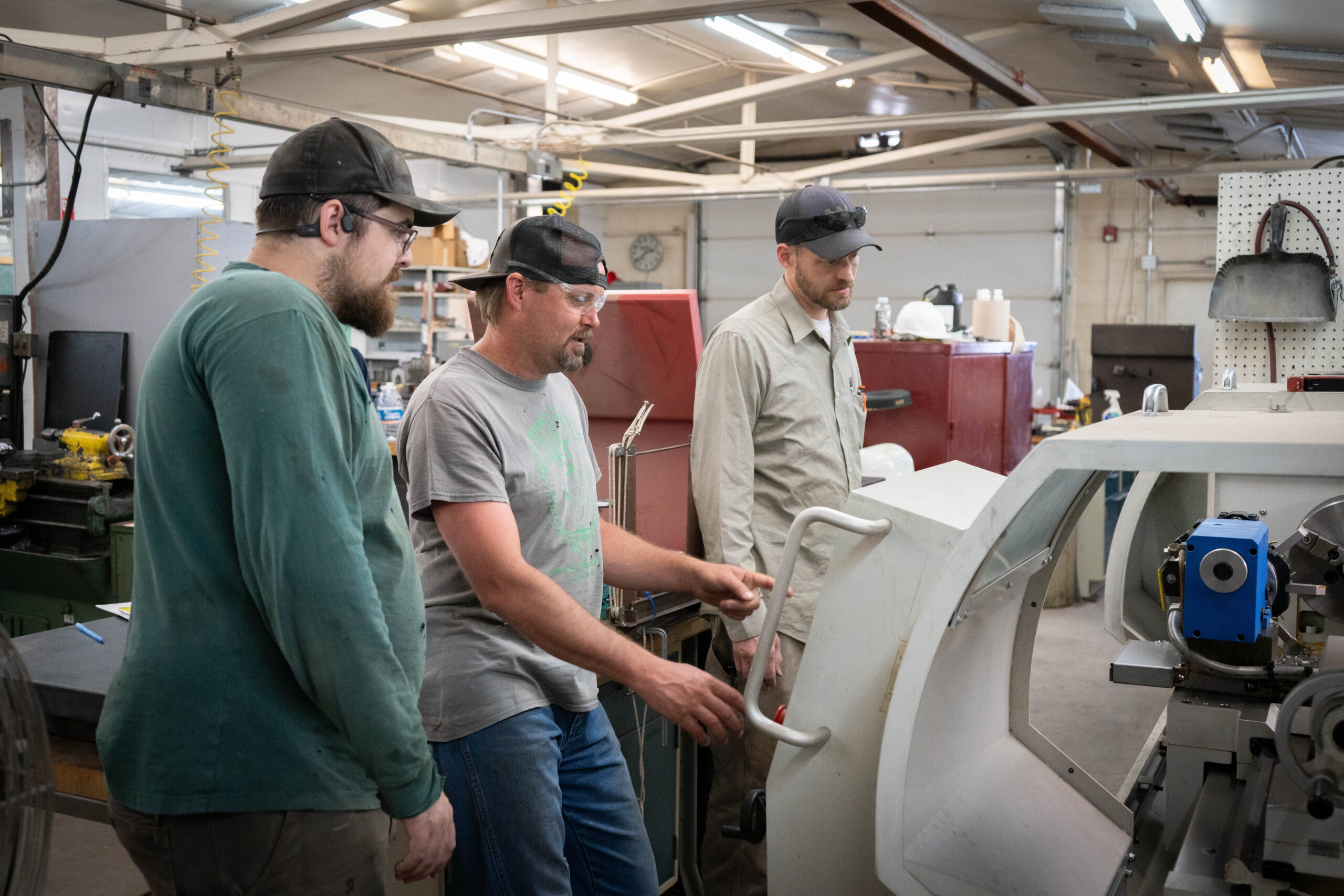 3 people figuring out the cnc mill machine