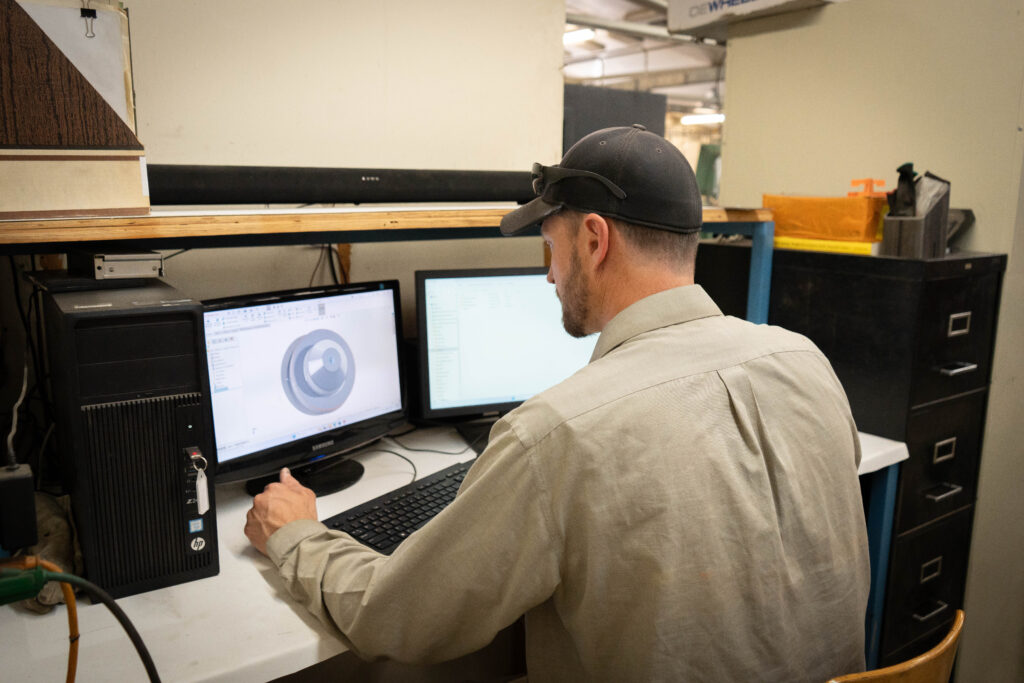 person working on CAD software in computer