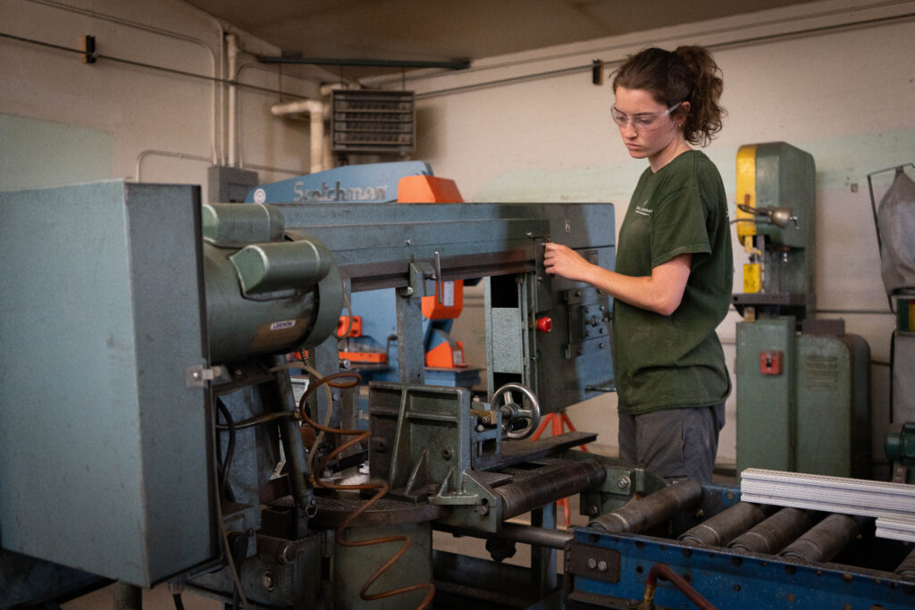 person working in a sawing machine