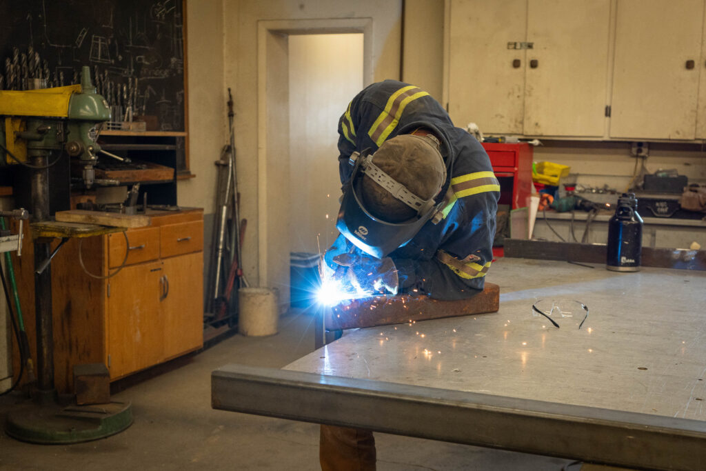 person sitting and doing welding work