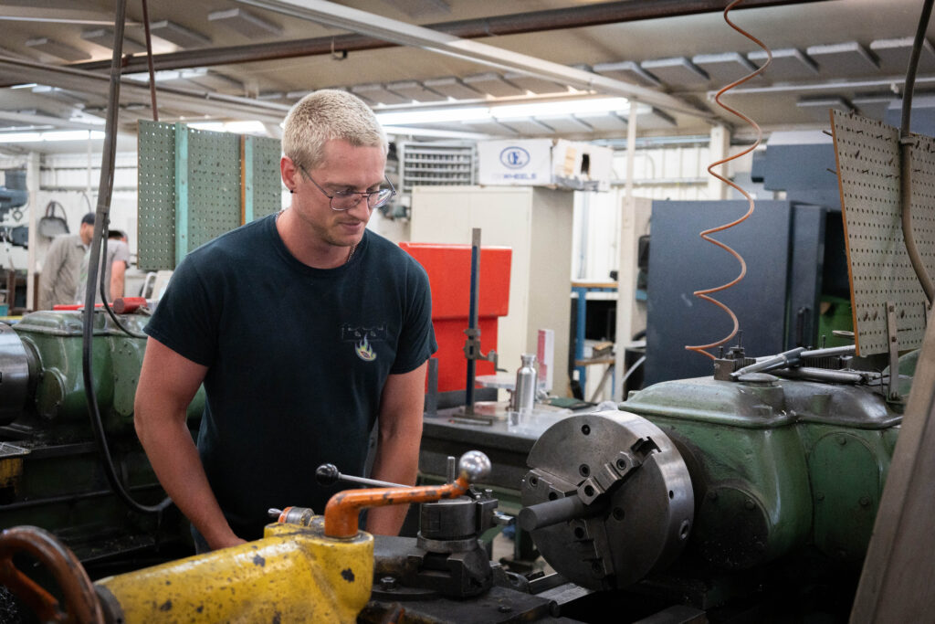 Person working in the lathe machine