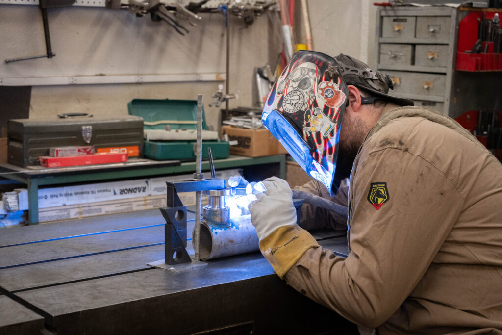 person sitting and doing welding work